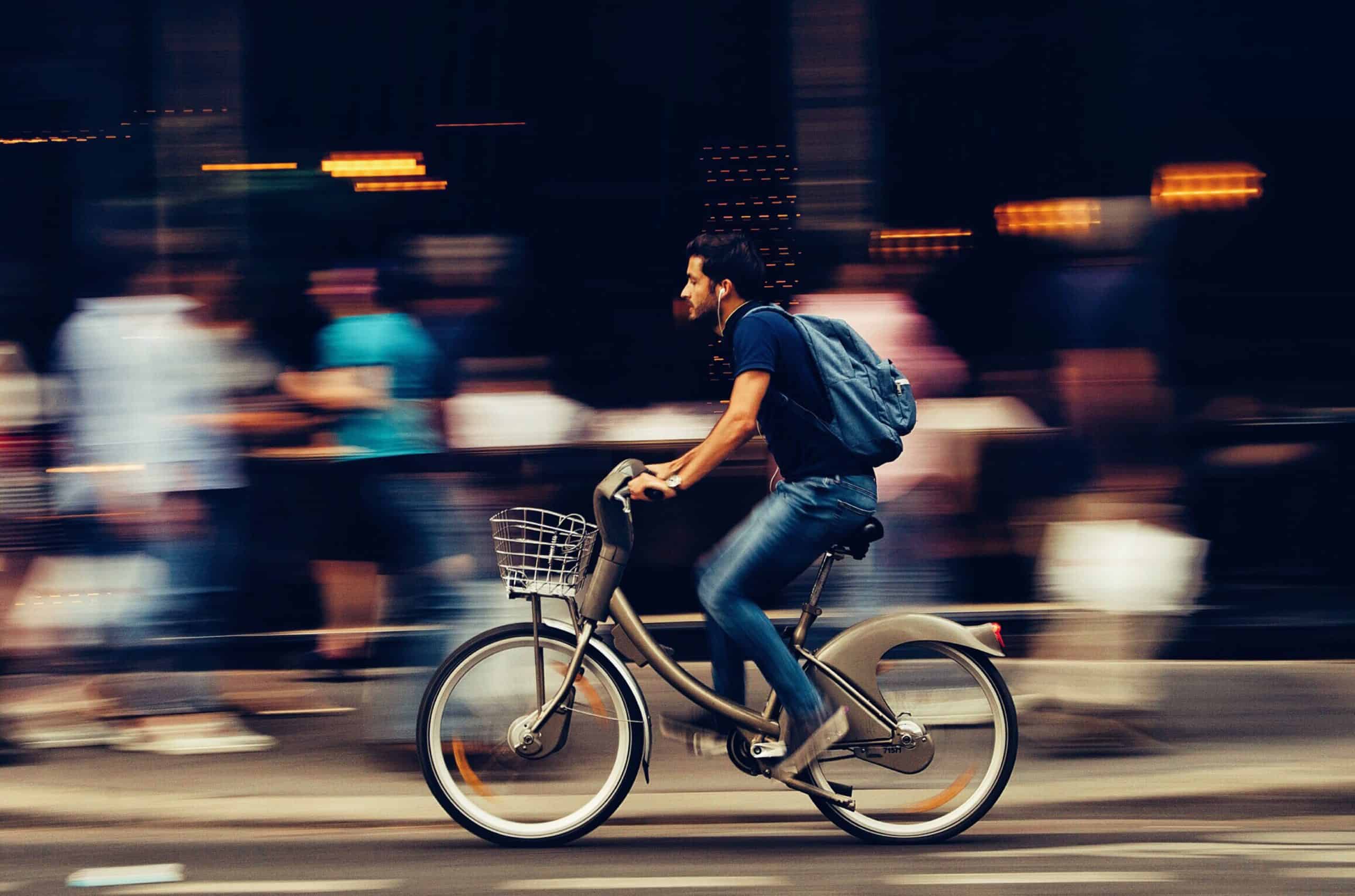 Man riding bicycle on city street