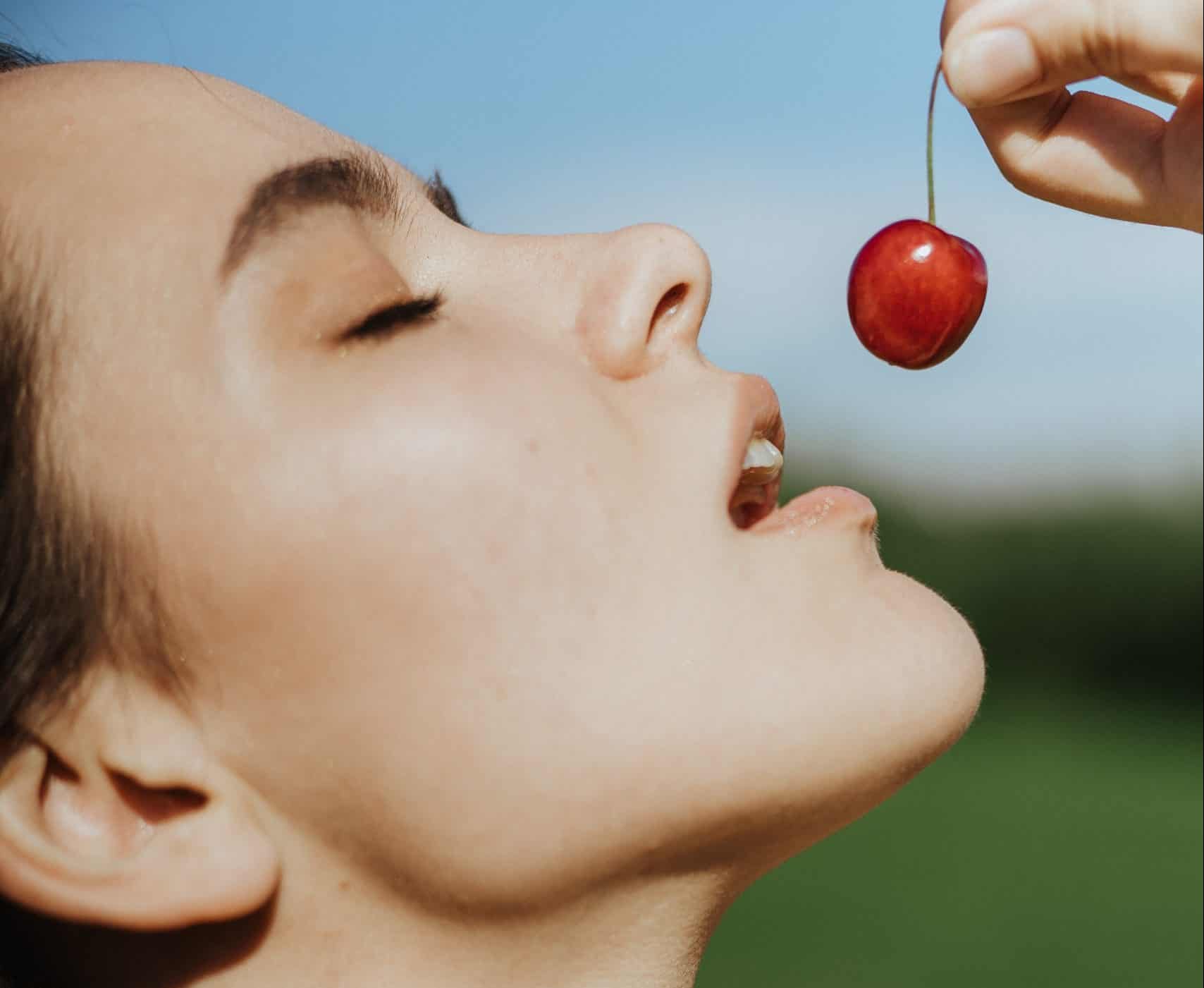 a-woman-about-to-eat-cherry-stockpack-pexels A woman about to eat cherry