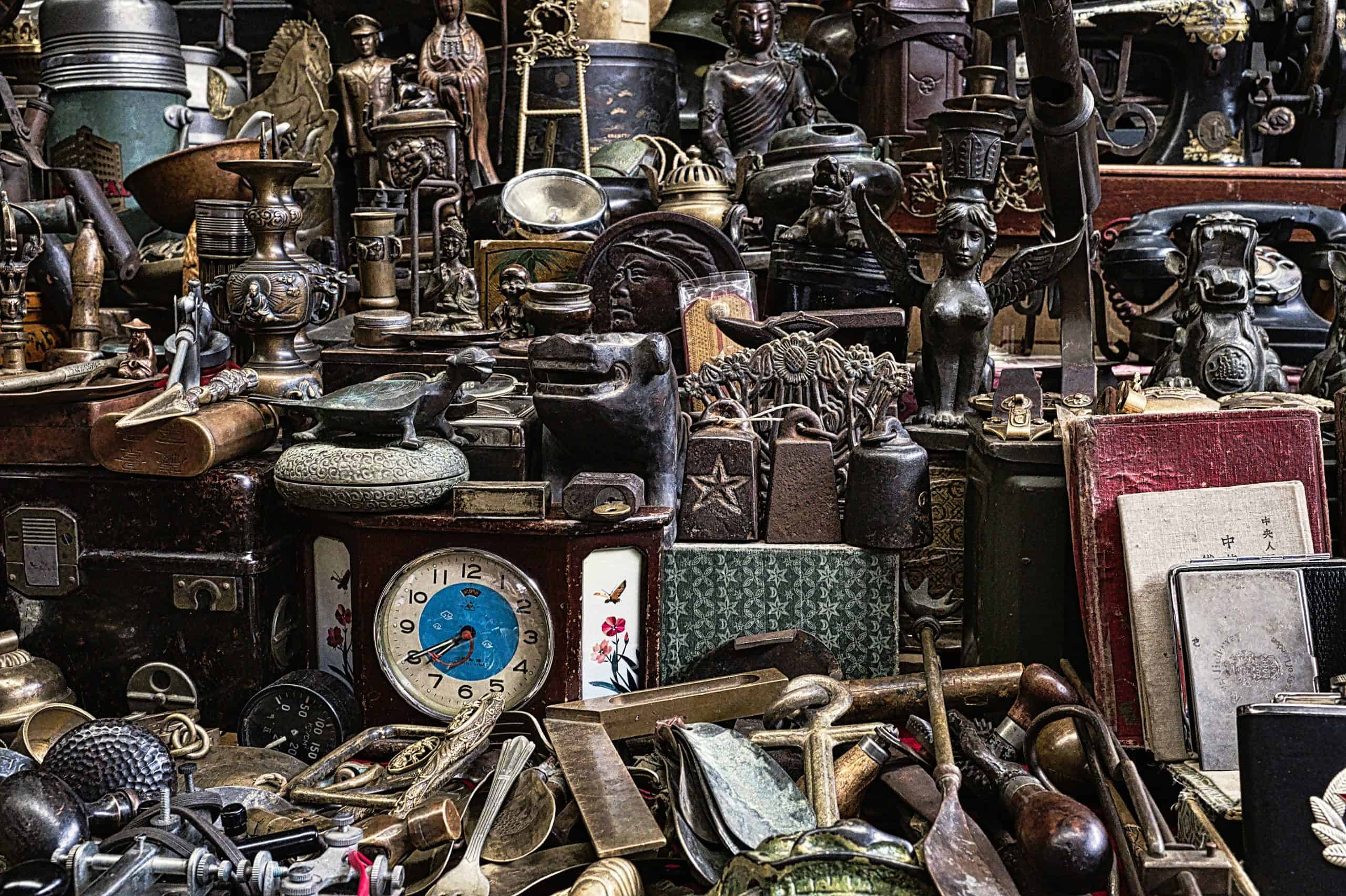 A Vibrant Collection of Antique Treasures Discovered in a Quaint Local Shop - An eclectic assortment of antique items fills the shelves of a quaint local shop. Vintage clocks, ornate figurines, and various metal trinkets are carefully displayed, reflecting a rich history and intriguing stories. Each piece showcases unique craftsmanship, drawing visitors into the charm of the past.